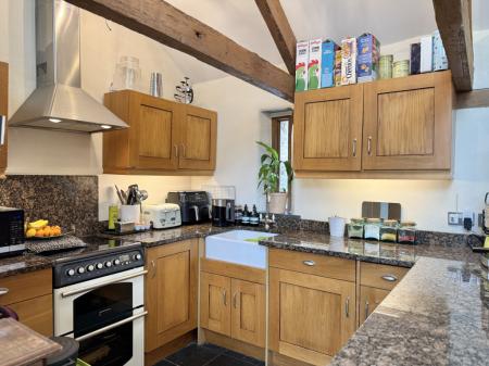 Kitchen with integrated appliances and granite worktops