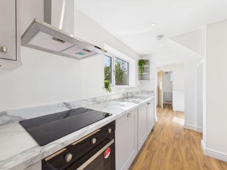Kitchen into the Utility area and Cloakroom