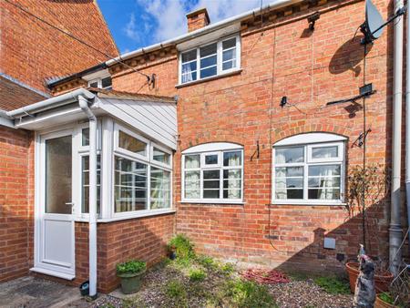 Sunlit Red-Brick House Exterior.png