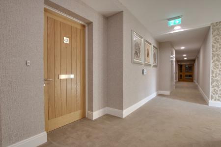 FRONT DOOR AND COMMUNAL HALLWAY