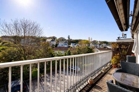 Sunlit balcony with suburban views.png